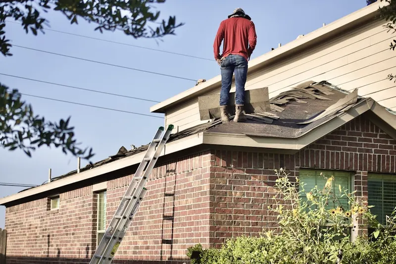 Professional roofer working on a residential roof in Edmondson